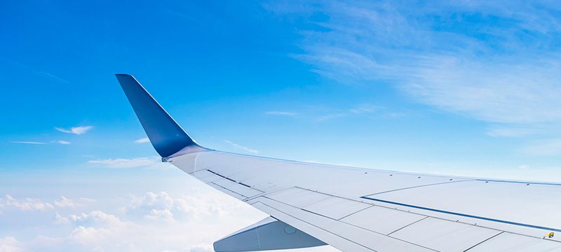 飛行機の客席から翼が見えて旅をイメージさせる画像