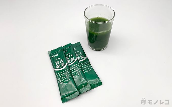 えがおの青汁満菜の個包装と青汁が入ったコップの画像